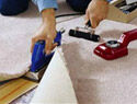 person cutting carpet