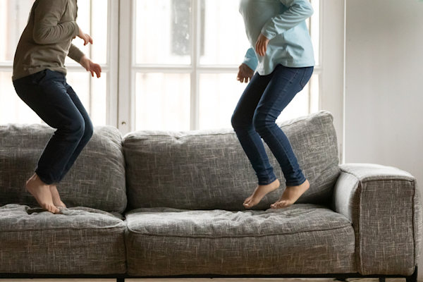 Kids jumping on couch.